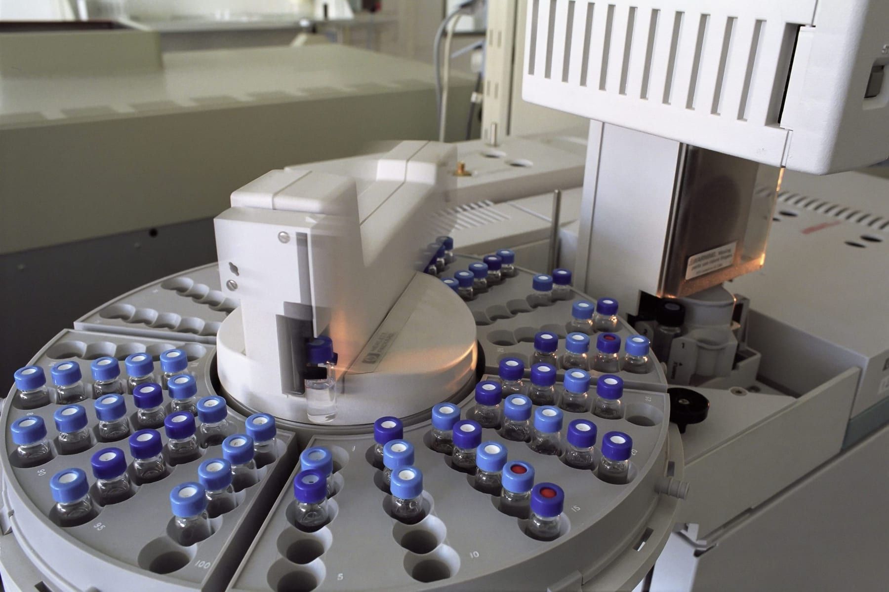 The autosampler tray of a gas chromatograph, loaded with capped sample vials.